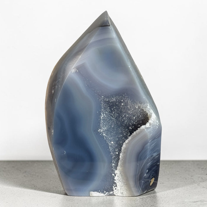 Kindred Crystal Collective — Natural Agate Flame, polished flame-shaped agate with warm honey, rust, grey, and ivory banding, 17x12cm