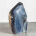 Kindred Crystal Collective — Natural Agate Flame, polished flame-shaped agate with warm honey, rust, grey, and ivory banding, 17x12cm