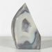 Kindred Crystal Collective — Natural Grey Agate Flame with Druzy Centre, freestanding flame-shaped stone with grey banding and polished and naturally textured surfaces.