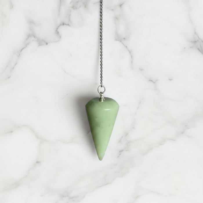 A rounded edge jade pendulum with a silver chain and a loop at the top for hanging.