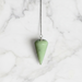 A rounded edge jade pendulum with a silver chain and a loop at the top for hanging.