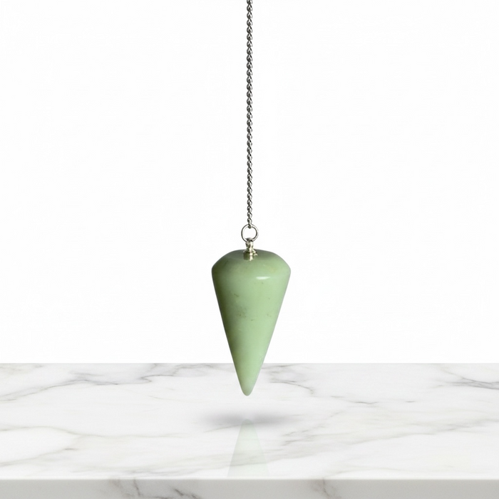 A rounded edge jade pendulum with a silver chain and a loop at the top for hanging.