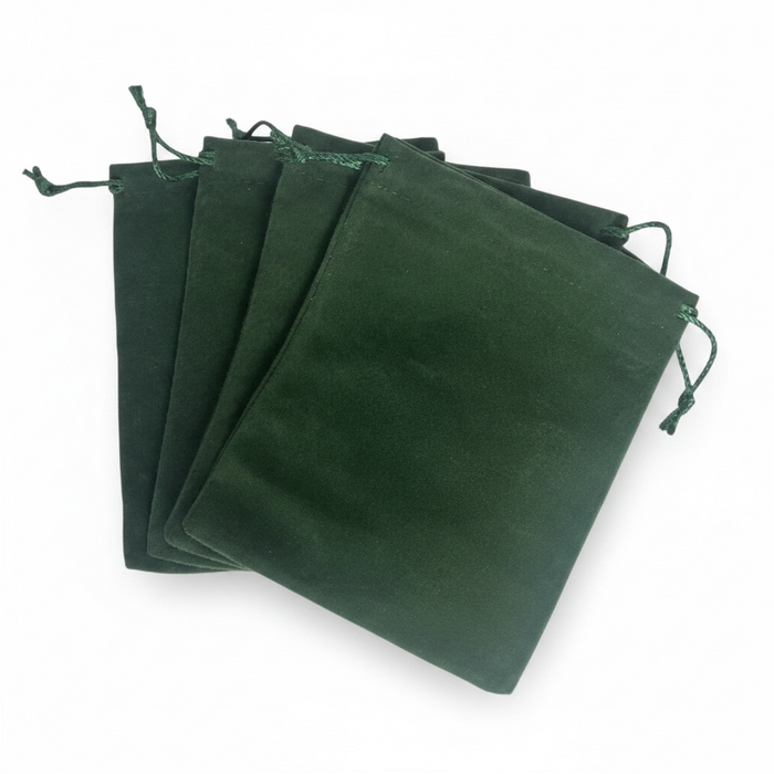 Set of green velvet drawstring bags on a white background