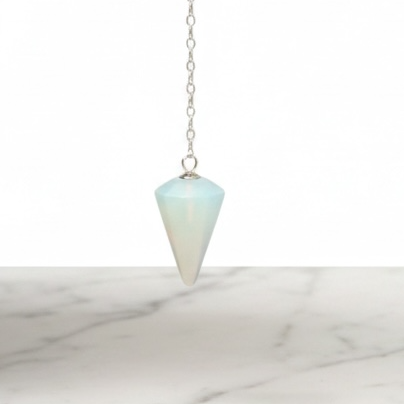Kindred Crystal Collective — Opalite Pendulum, faceted iridescent opalite pendulum held on silver chain, white background