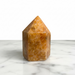 Kindred Crystal Collective — Orchid Calcite Generator, polished warm amber-orange orchid calcite generator point, front view on white background
