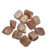 Kindred Crystal Collective - Eleven polished Pink Calcite tumbled stones in soft blush and peachy-pink tones with a smooth rounded finish.