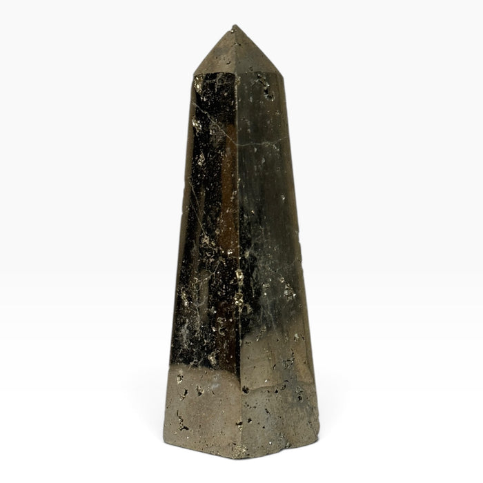 Kindred Crystal Collective — Pyrite Obelisk, brass-gold metallic crystal tower with smooth faces, textured pockets and a pointed tip.