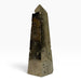 Kindred Crystal Collective — Pyrite Obelisk, brass-gold metallic crystal tower with smooth faces, textured pockets and a pointed tip.