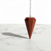 Red jasper crystal pendulum with speckled red surface, faceted point for chakra alignment and energy work