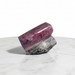 Kindred Crystal Collective — Rhodonite Free Form, deep rose-pink and black veined rhodonite freeform with polished top and raw grey base, white background