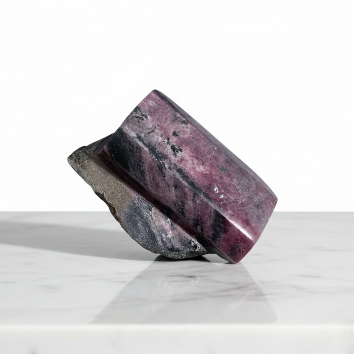 Kindred Crystal Collective — Rhodonite Free Form, deep rose-pink and black veined rhodonite freeform with polished top and raw base, white background