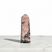 Rhodonite obelisk 156g in vibrant pink with black manganese oxide veining, a powerful crystal tower for love, compassion and root chakra grounding