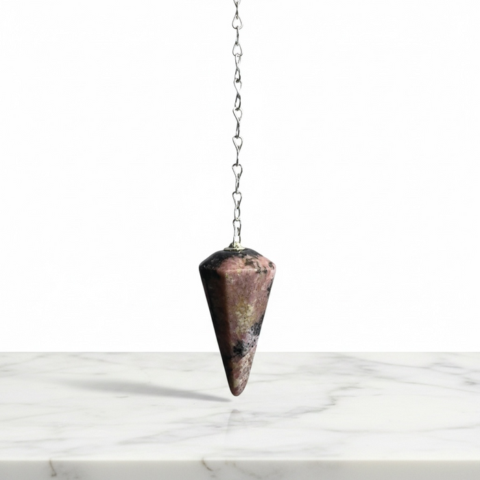 Rhodonite Pendulum crystal on white background — pink stone with black manganese veining