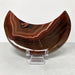 Kindred Crystal Collective — Sardonyx Crescent Moon, polished red-brown and charcoal stone carving with fine white banding.