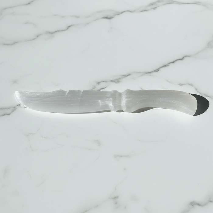 Natural selenite serrated wand 360g with jagged sword edge and soft white glow, for cord cutting, energy cleansing and spiritual clarity