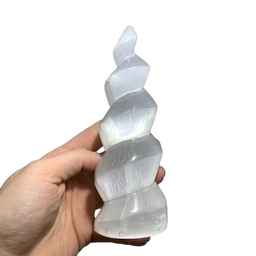 Kindred Crystal Collective — Selenite Spiral Tower, white selenite spiral tower 15cm, size reference with hand showing larger size