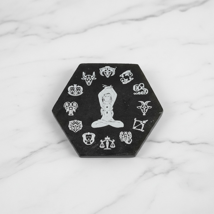 Selenite zodiac plate hexagon in black and white with engraved zodiac symbols, a crystal charging plate for cleansing and protection