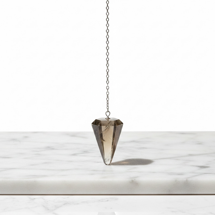 Natural smoky quartz faceted pendulum in translucent grey-brown, hanging on a silver chain