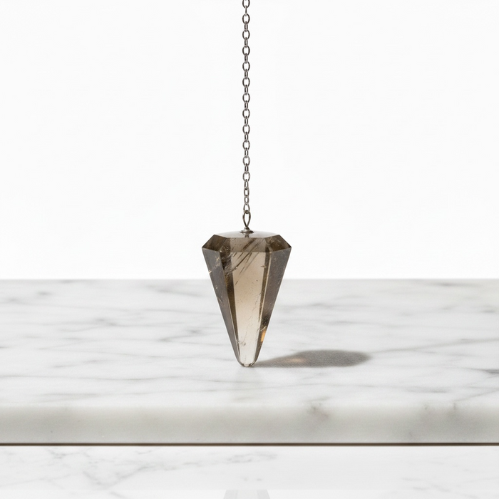 Natural smoky quartz faceted pendulum in translucent grey-brown, hanging on a silver chain