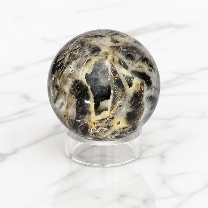 Kindred Crystal Collective — Sphalerite Sphere, natural sphalerite polished sphere in warm amber and honey tones with exceptional refractive brilliance, 70mm