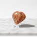 Natural sunstone carved crystal heart in warm reddish-orange with glittering aventurescence, 90g, for vitality and good fortune