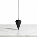 Shungite crystal pendulum close-up showing deep matte black carbon surface, used for energy healing and balance