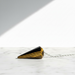Tigers Eye Gold Pendulum crystal on white background — golden brown chatoyant stone