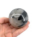 A spherical tourmaline quartz crystal held in a person's hand, with a blurred background.