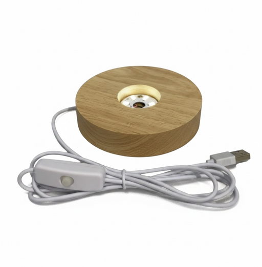 Colorful spherical light on a wooden base with USB cable on a white background