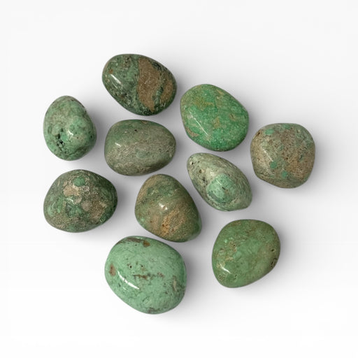 Kindred Crystal Collective — Variscite Tumbled Stones, ten polished bright mid-green to vivid green Variscite tumbles showing warm amber-brown matrix patches and mottled patterning with high-gloss finish, white background