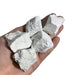 Kindred Crystal Collective — White Howlite Rough 1KG, white and grey veined raw howlite chunks spilling from a clear bag on white background.