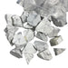 Kindred Crystal Collective — White Howlite Rough 1KG, white and grey veined raw howlite chunks spilling from a clear bag on white background.