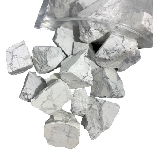 Kindred Crystal Collective — White Howlite Rough 1KG, white and grey veined raw howlite chunks spilling from a clear bag on white background.