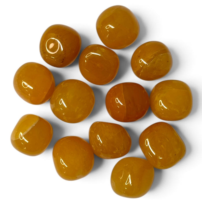 Kindred Crystal Collective — Yellow Aventurine Tumbled 2-3cm, polished honey-yellow and golden-ochre stones with occasional pale veins on a white background.