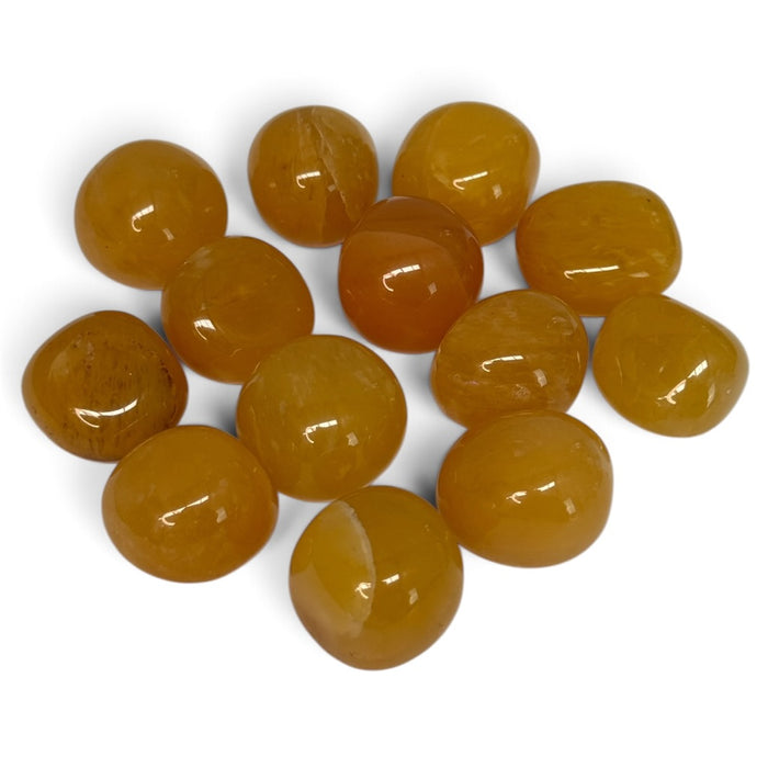 Kindred Crystal Collective — Yellow Aventurine Tumbled 2-3cm, polished honey-yellow and golden-ochre stones with occasional pale veins on a white background.