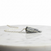 Zebra Jasper Pendulum crystal on white background  distinctive black and white striped pattern