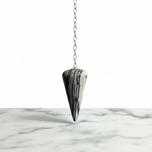Zebra Jasper Pendulum crystal on white background  distinctive black and white striped pattern