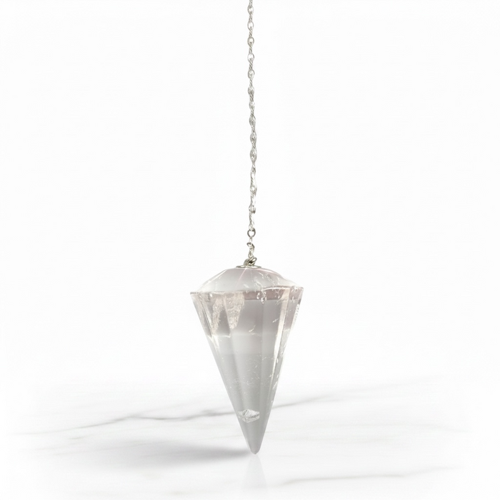 Clear Quartz Pendulum crystal on white background natural clarity and luminous finish