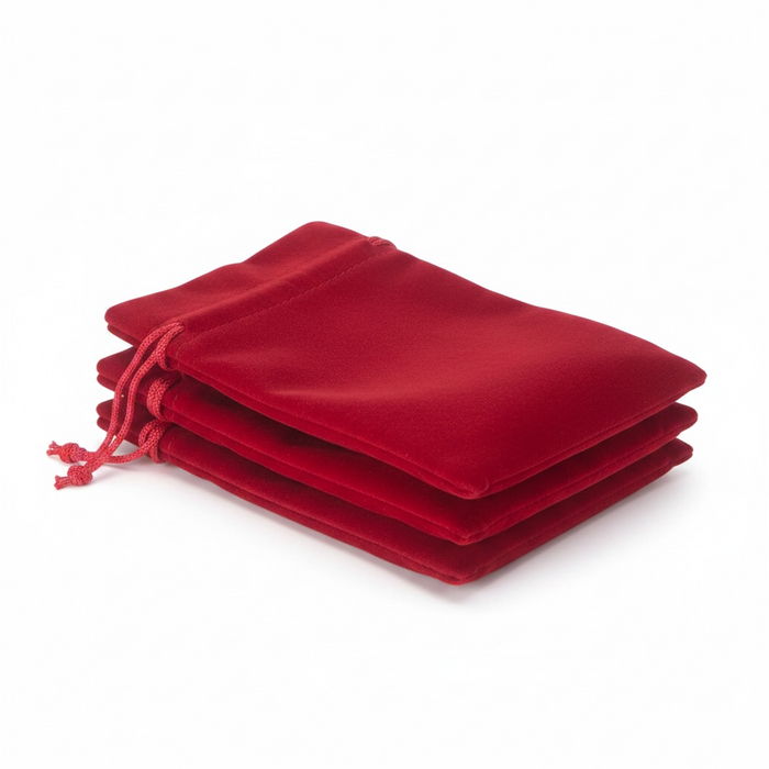 Stack of dark red velvet drawstring bags on a white background