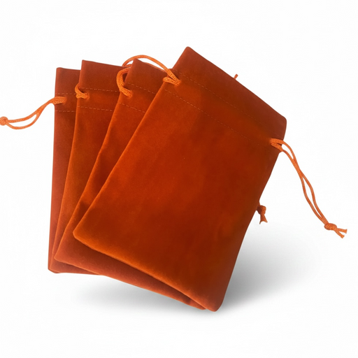 Orange velvet drawstring bags on a white background
