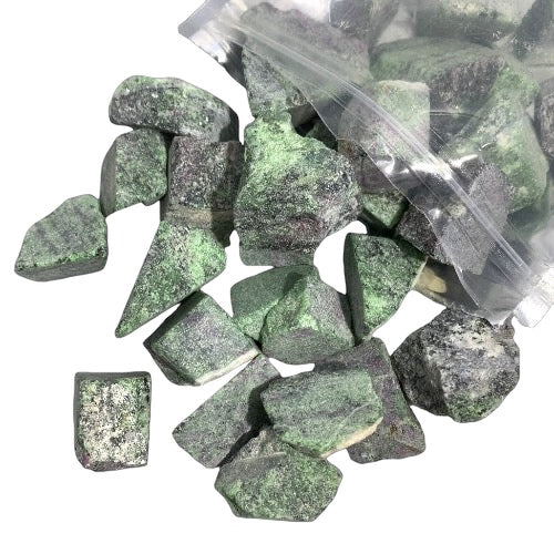 A clear plastic bag filled with rough green ruby zoisite stones of various shapes and sizes.