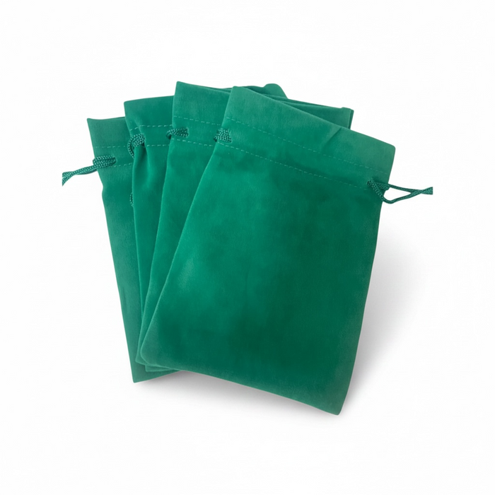 stack of green velvet drawstring bags on a white background