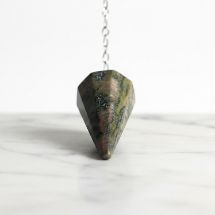 Unakite Pendulum - Pink Based crystal on white background distinctive pink and green tones