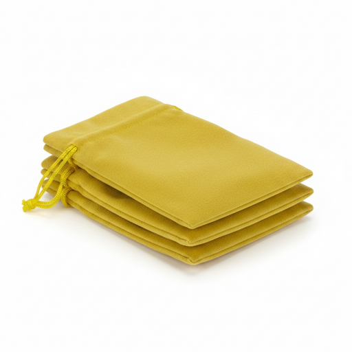 Stack of yellow velvet drawstring bags on a white background