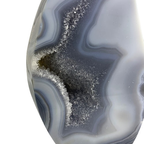 Kindred Crystal Collective — Agate Druzy Flame, close-up of sparkling grey druzy crystal cavity with concentric agate banding, variant 1