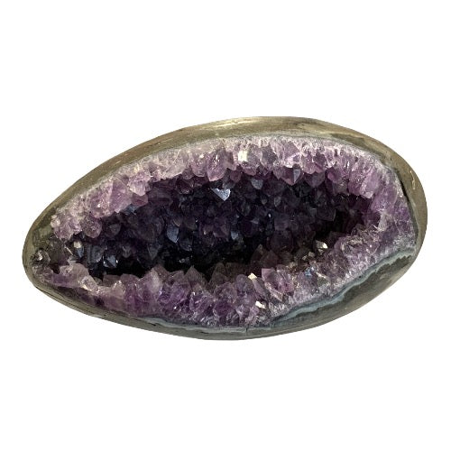Amethyst geode egg close-up showing sparkling purple crystal interior within smooth polished egg shell, a breathtaking statement collector's crystal piece
