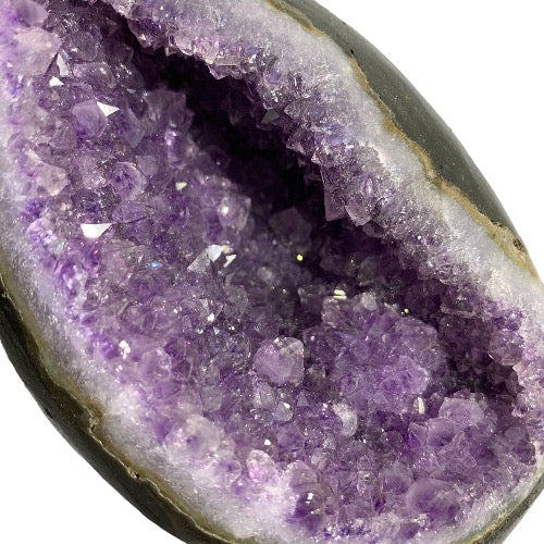 Kindred Crystal Collective — Amethyst Geode Egg, close-up detail of natural amethyst druzy crystal points inside polished geode egg cavity
