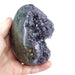Amethyst druzy cluster egg close-up showing glittering purple crystals within polished exterior, a healing crystal for peace and third eye chakra