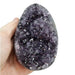 Amethyst druzy cluster egg close-up showing glittering purple crystals within polished exterior, a healing crystal for peace and third eye chakra