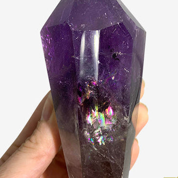 Kindred Crystal Collective — Amethyst Point, close-up of deep violet amethyst crystal tip with natural rainbow iridescence and internal inclusions visible